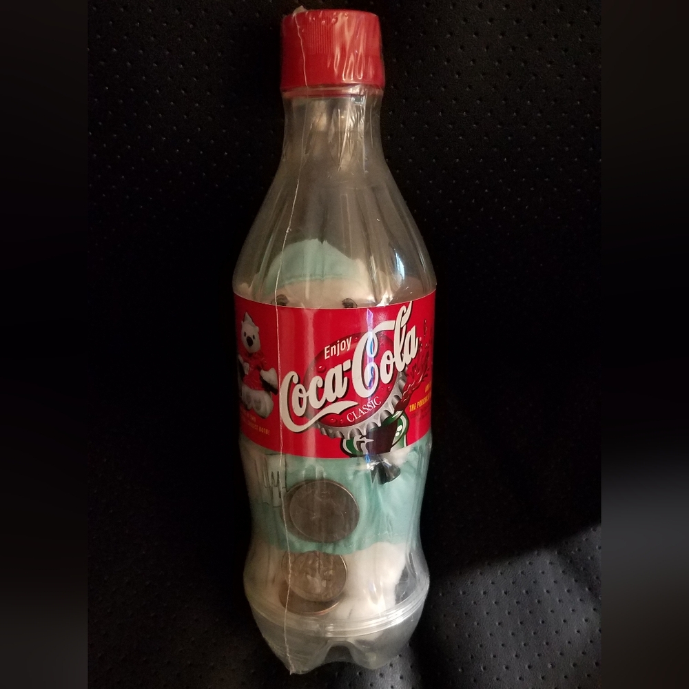 Coca-Cola bottle bank with Plush Polar Bear Prize bottle unopened with quarters.